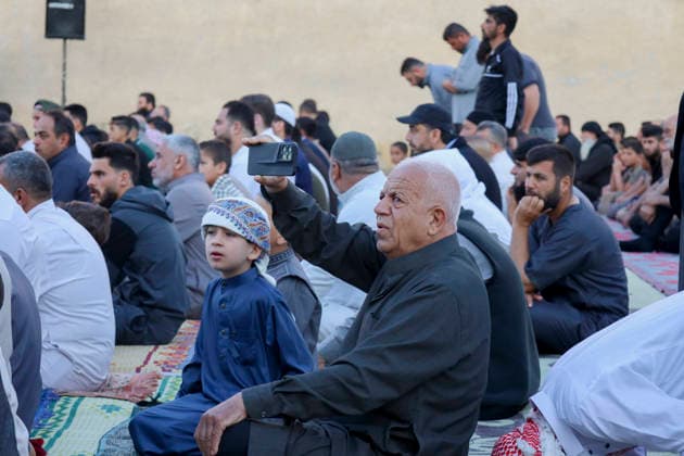 Eid Al-Adha Prayers Idlib An elderly man holds a mobile phone while sitting with others on prayer rugs before Eid al-Adha prayers in Idlib, Syria, on May 27, 2026. Eid al-Adha, or the Feast of Sacrifice, is one of the most important holidays in the Islamic calendar, commemorating the willingness of Prophet Ibrahim to sacrifice his son. The event is traditionally marked worldwide by communal prayers, family gatherings, acts of charity, and the slaughtering of livestock. Idlib Idlib Syria Copyright: xOmarxAlbawx