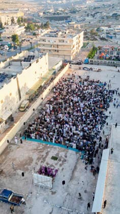 Eid Al-Adha Prayers Idlib An aerial view shows a large crowd of worshipers performing Eid al-Adha prayers in Idlib, Syria, on May 27, 2026. Eid al-Adha, or the Feast of Sacrifice, is one of the most important holidays in the Islamic calendar, commemorating the willingness of Prophet Ibrahim to sacrifice his son. The event is traditionally marked worldwide by communal prayers, family gatherings, acts of charity, and the slaughtering of livestock. Idlib Idlib Syria Copyright: xOmarxAlbawx