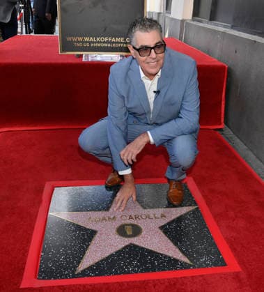 Comedy, actor, radio personality and television host Adam Corolla touches his star during an unveiling ceremony honoring him with the 2,846th star on the Hollywood Walk of Fame in Los Angeles on Wednesday, May 27, 2026.  LAP2026052715 JIMxRUYMEN