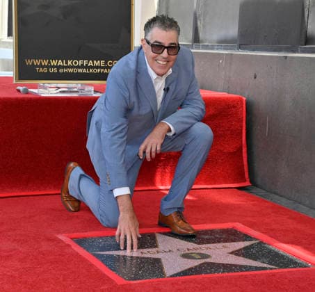 Comedy, actor, radio personality and television host Adam Corolla touches his star during an unveiling ceremony honoring him with the 2,846th star on the Hollywood Walk of Fame in Los Angeles on Wednesday, May 27, 2026.  LAP2026052714 JIMxRUYMEN