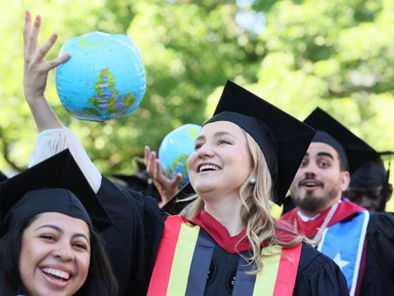 Crown Princess Elisabeth (C) and her fellow graduates celebrate with inflatable globes, at a Harvard university-wide celebration at Harvard Yard, part of the Class of 2026 graduation days in Harvard University, in Cambridge, USA, Thursday 28 May 2026.  BENOITxDOPPAGNE 175270567