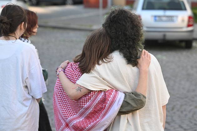 The situation in front of the District Court in Pardubice, where a custody hearing is underway with a man accused of intentionally setting fire to the LPP Holding hall, 28 May 2026, Pardubice, Czech Republic. Several supporters, including girls, came to support the detainee in front of the court building with Palestinian scarves and banners. Criminal investigators are accusing him of the crime of a terrorist attack and participation in a terrorist group. According to earlier reports, police have detained ten people in connection with this case. A fire broke out on March 20 in the production hall of the LPP Holding arms factory in Pardubice. The Earthquake Faction alleged anti-Israel group claimed responsibility for the fire. The group state  CTKPhotoP2026052808317