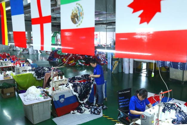 QINGDAO, CHINA - MAY 28: Workers are busy in front of an assembly line of flags for the FIFA World Cup at Qingdao Wonderful Flag Industry Co on May 28, 2026 in Qingdao, Shandong Province of China. As the 2026 FIFA World Cup is around the corner, production lines at a flag manufacturer in Qingdao, Shandong province, are running at full speed to produce various types of flags, many of which will soon appear in stadiums across North America.  Copyright: xVCGx 111644611662