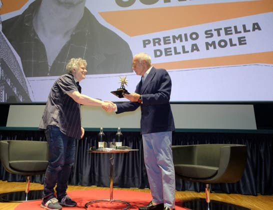 Michel Gondry At Stella Della Mole Award Ceremony - Turin French director Michel Gondry receives the Stella della Mole award in recognition of his contribution to filmmaking during a ceremony at Cinema Massimo in Turin, Italy, on May 28, 2026 alongside National Cinema Museum director Carlo Chatrian, as he reviews his eclectic career and introduces the screening of Microbo&Gasolina. Photo by Costantino Sergi IPA ABACAPRESS.COM Torino Torino  Copyright: xIPA ABACAx