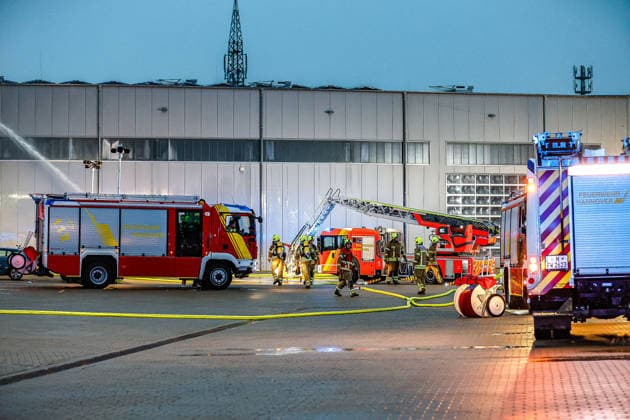 Großbrand in einer Lager- und Logistikhalle Einsatz eines Wasserwerfers am Boden (links hinten) der Löschwasser auf das Dack abgibt. Eine Drehleiter wird in Stellung gebracht. Hannover-Anderten Lohweg 7, Gewerbegebiet Niedersachsen, Region Hannover Germany *** Large fire in a warehouse and logistics hall Use of a water cannon on the ground at the rear left to discharge extinguishing water onto the roof A turntable ladder is brought into position Hanover Anderten Lohweg 7, Lower Saxony industrial estate, Hanover region Germany