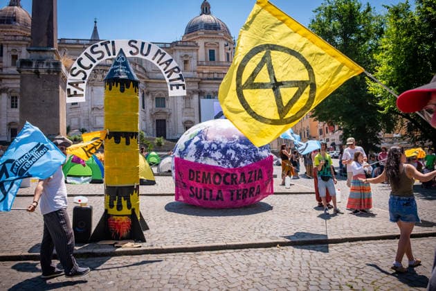 May 30, 2026, Rome, Rm, Italy: Extinction Rebellion activists are launching a 24-hour rally in Piazza dell Esquilino, just days before the 80th anniversary of the Italian Republic on June 2nd. They say: there is nothing to celebrate as long as rights, justice, and dignity continue to be denied. Oil extraction is imposed through violence and war to produce ever more energy, further increasing inequality. Activists assembled a rocket made of oil drums. It reads: Fascists on Mars. Democracy on earth reads the banner. Rome Italy - ZUMAg256 20260530_znp_g256_007 Copyright: xMarcoxDixGianvitox