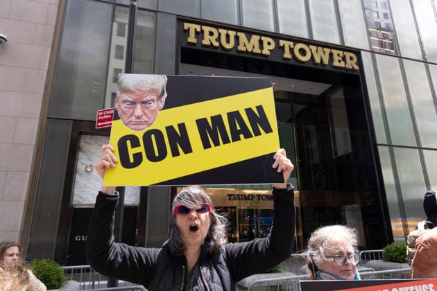 May 30, 2026, New York, New York, USA: Demonstrators join Rise and Resist s Impeach Convict Remove anti-Trump protest in front of Trump Tower on Fifth Avenue in Midtown Manhattan. A person holds a sign with an image of President Trump that reads CON MAN. Organizers call for impeachment stating that President Trump violates the Constitution, is covering up the Epstein Files, and is using his office to grift citing stock trades, crypto assets, the ballroom and the slush fund for Jan 6 insurrectionists. New York USA - ZUMAr174 20260530_znp_r174_018 Copyright: xGinaxMxRandazzox