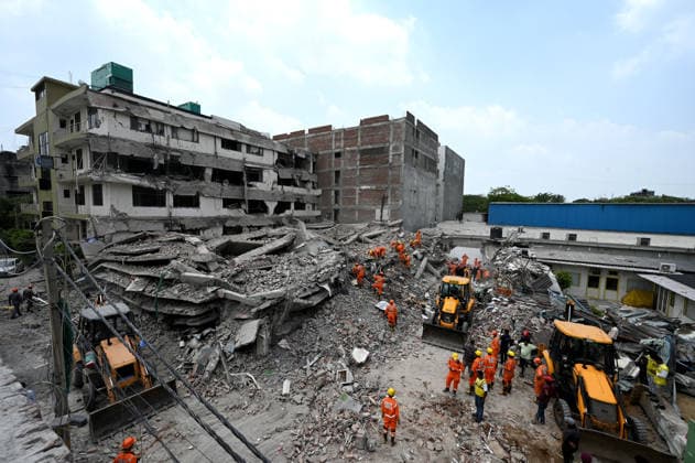 NEW DELHI, INDIA - MAY 31: NDRF team conducts rescue operations at the site of a five-storey building collapse on Westend Marg in Saidulajab, South Delhi, on May 31, 2026 in New Delhi, India. A rescue operation was conducted overnight to pull survivors out of the debris as authorities continue search efforts in the hope of pulling out more people. This is a multi-agency rescue operation, including teams from the National Disaster Response Force (NDRF), Delhi Fire Services (DFS), Delhi Police, Delhi Disaster Management Authority (DDMA), Municipal Corporation of Delhi (MCD), Civil Defence and CATS Ambulance Service. Heavy machinery, hydraulic cutters, victim-location cameras and sniffer dogs were used by the rescue operation teams to maximise