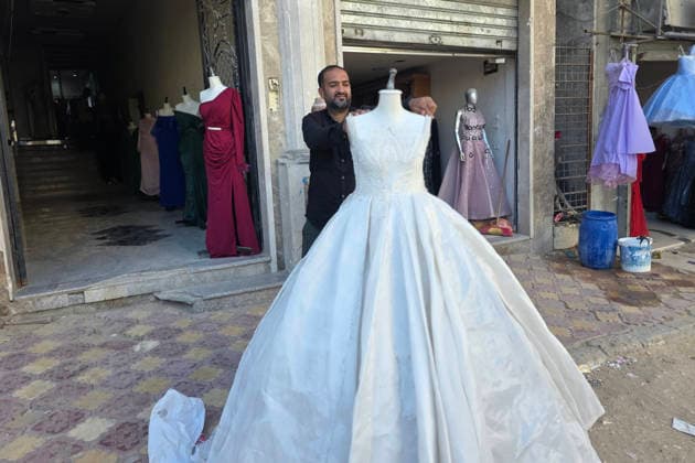 Customers browse wedding attire in Khan Younis despite wartime hardships Customers browse wedding dresses and suits inside a bridal shop in Khan Younis in the southern Gaza Strip on June 1, 2026, as Palestinians continue to uphold marriage traditions despite the ongoing war, widespread destruction, and difficult economic and humanitarian conditions. Shop owners say demand for wedding supplies remains present, though at a lower pace, as many families turn to less costly options amid declining incomes, rising prices, and shortages of goods linked to Israeli restrictions at border crossings. Photo by Tariq Mohammad APA Images Khan Yunis Gaza Strip Palestinian Territory 010626_Khan_Yunis_TM_00(31) Copyright: xapaimagesxTariqxMohammad xapaimagesx