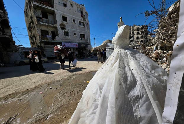 Customers browse wedding attire in Khan Younis despite wartime hardships Customers browse wedding dresses and suits inside a bridal shop in Khan Younis in the southern Gaza Strip on June 1, 2026, as Palestinians continue to uphold marriage traditions despite the ongoing war, widespread destruction, and difficult economic and humanitarian conditions. Shop owners say demand for wedding supplies remains present, though at a lower pace, as many families turn to less costly options amid declining incomes, rising prices, and shortages of goods linked to Israeli restrictions at border crossings. Photo by Tariq Mohammad APA Images Khan Yunis Gaza Strip Palestinian Territory 010626_Khan_Yunis_TM_00(20) Copyright: xapaimagesxTariqxMohammad xapaimagesx