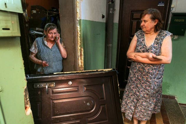 A woman talks on the phone as she stands by the door to an apartment in a nine-storey apartment block hit by a Russian drone in Dnipro, Ukraine, on 2 June 2026. During the day, Russian occupation forces carried out another strike on the city, targeting a block of flats with a jet drone. As a result of the direct hit, one apartment burned to the ground, and neighbouring flats also sustained significant damage. Two children were injured and taken to the hospital with moderate injuries. (Photo by Mykola Miakshykov Ukrinform) Russian drone strikes block of flats in Dnipro  Copyright: xMykolaxMiakshykovx