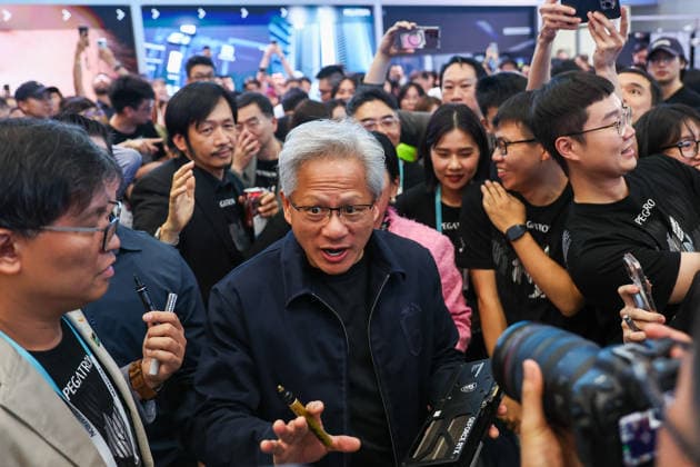 NVIDIA s CEO Jensen Huang visits COMPUTEX TAIPEI 2026 TAIPEI, TAIWAN - JUNE 3: Jensen Huang, the CEO of American multinational tech giant NVIDIA, signs autographs for fans as he is surrounded by heaps of supporters and staff during his visit to the COMPUTEX TAIPEI trade show, in Taipei, Taiwan, on June 3, 2026. COMPUTEX TAIPEI is one of the world’s largest and most significant trade shows, featuring latest technologies, drones, data centres, Artificial Intelligence (AI) technologies, supercomputers, semiconductors products and other things from major international firms such as Nvidia, Intel, NXP and Foxconn. Daniel Ceng Anadolu Taipei Taiwan. Editorial use only. Please get in touch for any other usage.  Copyright: x2026xAnadoluxDanielxCengx
