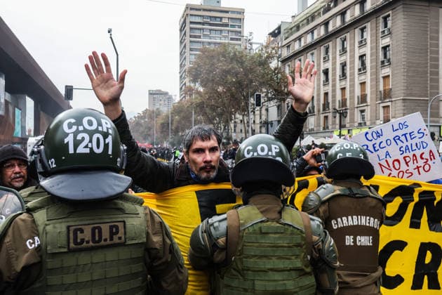 Thousands of students take to Chilean streets over planned education cuts SANTIAGO, CHILE - JUNE 3: A protester raises his arms in front of police officers during a protest against the government in Santiago, Chile, on June 3, 2026. Thousands of protesters took to the streets of Santiago to demonstrate against the austerity measures announced by President Jose Antonio Kast during his last State of the Nation address. Cristobal Basaure Anadolu Santiago Chile. Editorial use only. Please get in touch for any other usage.  Copyright: x2026xAnadoluxCristobalxBasaurex
