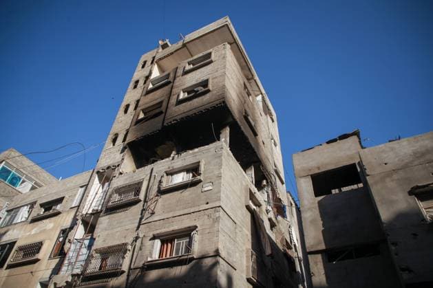 RECORD DATE NOT STATED Widespread Destruction and Resilience Amid Ongoing Humanitarian Crisis in Gaza City (INT) Widespread Destruction and Resilience Amid Ongoing Humanitarian Crisis in Gaza City. June 4, 2026, Gaza, Palestine: Widespread destruction clears a path through residential areas in Gaza City, where multi-story buildings stand heavily burned and damaged . Amidst the ruins, local residents and youth attempt to clear dark ash and rubble using primitive tools from the upper floors of targeted structures , while the streets are lined with shattered civilian vehicles covered in debris The scenes reflect the catastrophic impact of the ongoing conflict on infrastructure and daily life, highlighting the severe humanitarian conditions faced by the population i  Copyright: xHashemxZimmox