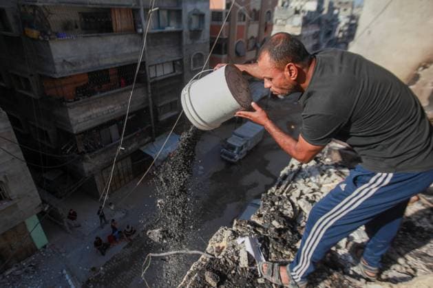 RECORD DATE NOT STATED Widespread Destruction and Resilience Amid Ongoing Humanitarian Crisis in Gaza City (INT) Widespread Destruction and Resilience Amid Ongoing Humanitarian Crisis in Gaza City. June 4, 2026, Gaza, Palestine: Widespread destruction clears a path through residential areas in Gaza City, where multi-story buildings stand heavily burned and damaged . Amidst the ruins, local residents and youth attempt to clear dark ash and rubble using primitive tools from the upper floors of targeted structures , while the streets are lined with shattered civilian vehicles covered in debris The scenes reflect the catastrophic impact of the ongoing conflict on infrastructure and daily life, highlighting the severe humanitarian conditions faced by the population i  Copyright: xHashemxZimmox