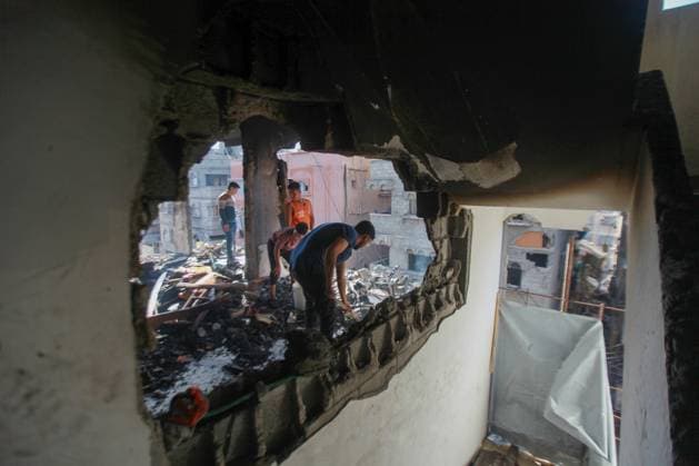 RECORD DATE NOT STATED Widespread Destruction and Resilience Amid Ongoing Humanitarian Crisis in Gaza City (INT) Widespread Destruction and Resilience Amid Ongoing Humanitarian Crisis in Gaza City. June 4, 2026, Gaza, Palestine: Widespread destruction clears a path through residential areas in Gaza City, where multi-story buildings stand heavily burned and damaged . Amidst the ruins, local residents and youth attempt to clear dark ash and rubble using primitive tools from the upper floors of targeted structures , while the streets are lined with shattered civilian vehicles covered in debris The scenes reflect the catastrophic impact of the ongoing conflict on infrastructure and daily life, highlighting the severe humanitarian conditions faced by the population i  Copyright: xHashemxZimmox