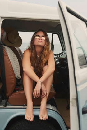 Woman, relax and car at beach for road trip with travel, sunglasses or break on holiday for summer getaway. Girl, vehicle and transportation with shades, pride and confidence on vacation with tourism. model released property released Copyright: x xBevanxGoldswainx