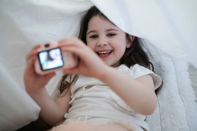 Smiling child taking a selfie with a toy camera under a blanket model released, Symbolfoto property released, ATSF00738