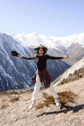 Happy hiker jumping in snowy mountain landscape model released, Symbolfoto, EYAF04115