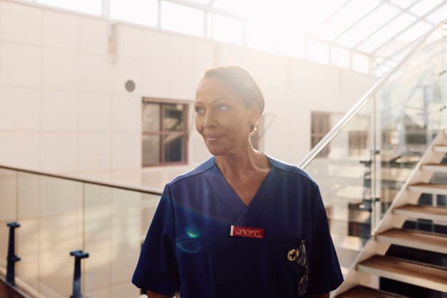 Short haired senior female nurse looking away while standing in hospital corridor Sweden, Stockholm, model released, property released Copyright: xMaskotx , MA124992 MA124992