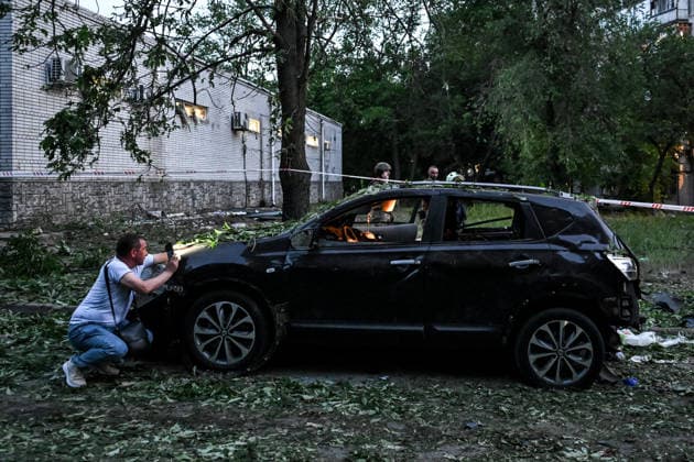 A man examines a car, damaged by a Russian drone strike on the Shevchenkivskyi district of Zaporizhzhia, Ukraine, June 4, 2026. Russian forces launched a drone strike on one of the city’s residential areas, killing one person and injuring 16 others. The blast wave and debris shattered windows and balconies in apartment blocks. (Photo by Dmytro Smolienko Ukrinform) Russian forces launch drone strike on district in Zaporizhzhia  Copyright: xDmytroxSmolienkox