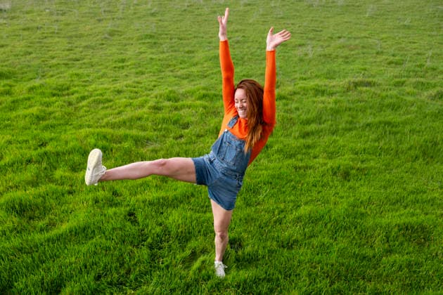 Joyful individual balancing in a grassy field in Spain model released, Symbolfoto, LMCF02817