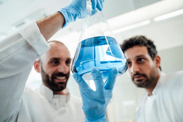 Scientist examining blue liquid in laboratory model released, Symbolfoto property released, RAYF01846
