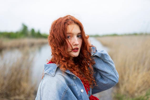 Woman with red hair in denim jacket outdoors in summer model released, Symbolfoto, VCF01563