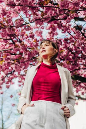 Businesswoman enjoying spring under a blooming cherry blossom tree model released, Symbolfoto, VSNF04879