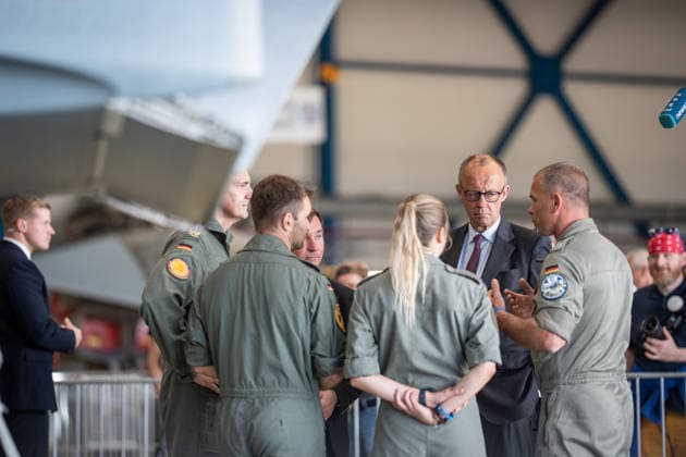 Federal Chancellor Friedrich Merz talks to servicemen and women in front of a Eurofighter fighter jet Federal Chancellor Friedrich Merz visits the air force base in Laage near Rostock, Laage, Rostock Mecklenburg-Vorpommern Germany Fliegerhost Laage