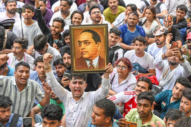 NEW DELHI, INDIA - JUNE 6: A Cockroach Janta Party (CJP) supporter during a protest over alleged irregularities in the country s major examinations on June 6, 2026 in New Delhi, India. Members and supporters of the Cockroach Janta Party (CJP) protest at Jantar Mantar to demand the resignation of Union Minister of Education, Dharmendra Pradhan. They claimed him to be directly responsible for the recent exam paper leaks in major national-level examinations across the country, including NEET. The party was started as a satirical online movement after remarks made by Chief Justice Surya Kant during a hearing. CJI Kant compared a section of young unemployed youth with fake law degrees to cockroaches. (Photo by Raj K Raj Hindustan Tim