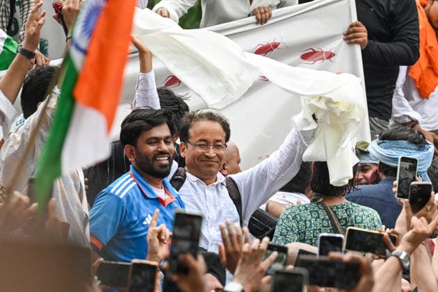 NEW DELHI, INDIA - JUNE 6: Cockroach Janta Party (CJP) founder Abhijeet Dipke, in blue, its spokespersons Saurav Das and Vijeta Dahiya, and Climate activist Sonam Wangchuk during a protest demanding the resignation of Union Education Minister Dharmendra Pradhan over alleged examination-related lapses, at the Jantar Mantar on June 6, 2026 in New Delhi, India. Members and supporters of the Cockroach Janta Party (CJP) protest at Jantar Mantar to demand the resignation of Union Minister of Education, Dharmendra Pradhan. They claimed him to be directly responsible for the recent exam paper leaks in major national-level examinations across the country, including NEET. The party was started as a satirical online movement after remarks made b