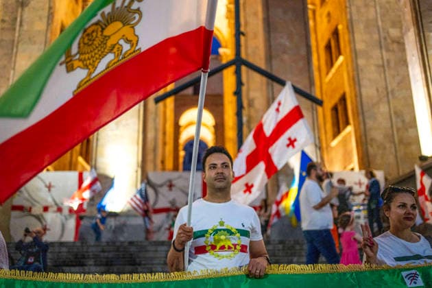 June 6, 2026, Tbilisi, Georgia: Tbilisi, Georgia, June 6, 2026. Iranian protesters hold Sun and Lion flag of Iran as they protest in front of the Georgian Parliament building on the 556th day of anti-government rallies in Tbilisi. Tbilisi Georgia  - ZUMAz174 20260606_zip_z174_003 Copyright: xMoexZoyarix