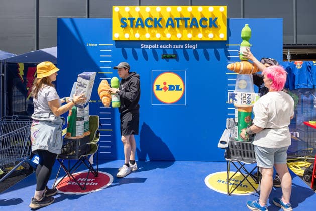 Musikfestival Rock im Park 2026, Nürnberg, 07.06.2026 Teilnehmer stapeln überdimensionale Lebensmittelattrappen beim Lidl-Aktionsspiel Stack Attack . Zwei Teams treten gegeneinander an, um Produkte so hoch wie möglich zu stapeln. Nürnberg Bayern Deutschland *** Rock im Park 2026 music festival, Nuremberg, 07 06 2026 Participants stack oversized food dummies in the Lidl Stack Attack action game Two teams compete against each other to stack products as high as possible Nuremberg Bavaria Germany 20260607-286A8412-M4000