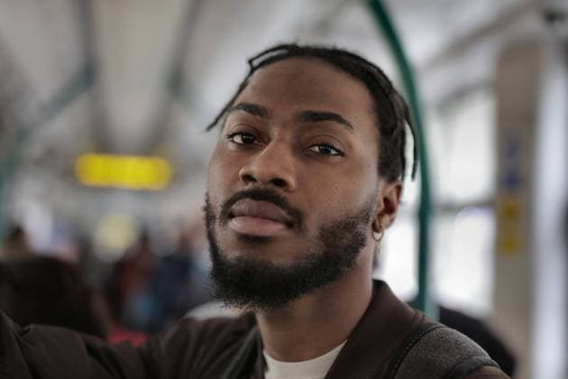 Young Black man looks at camera on public transit Budapest, Hungary CR_MIPI260603A-2045676-01 ,model released, Symbolfoto