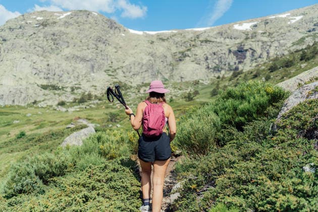Woman with backpack hiking up a rocky mountain trail Rascafría, Community of Madrid, Spain CR_NSRZ260605C-2046070-01 ,model released, Symbolfoto