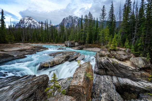 Creative Highlights World Natural Bridge falls with turquoise water in Yoho National Park Field, British Columbia, Canada CR_UGOUSD260604-2043994-01