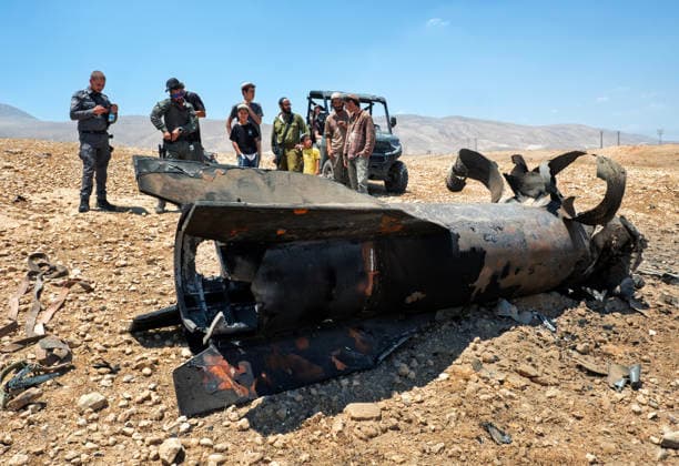 Israeli military personnel and Jewish settlers look at the remains of an Iranian ballistic that was removed from the desert landscape in the area near Jericho, in the West Bank on Monday, June 8, 2026 after it was intercepted by Israel and fell to the desert. Iran fired barrages of missiles and Israel carried out military strikes on both Beirut and Iran. Both Iran and Israel have signaled they would wind down the military escalation that shattered the two month ceasefire.  ISR20260608008 JimxHollander