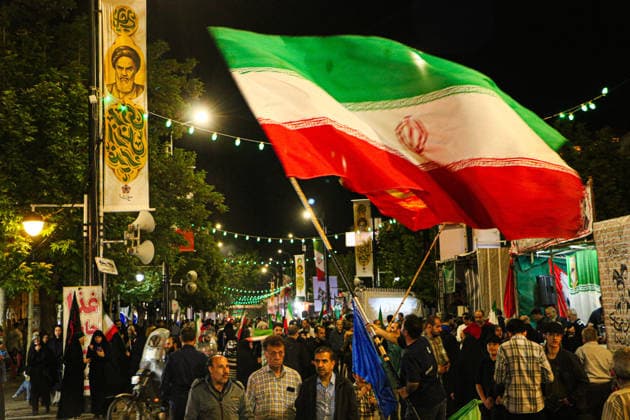 June 8, 2026, Iran, Iran: A supporter waves an Iranian national flag above a crowd during a state-organized rally in Iran. Air raid sirens sounded in Israel on June 7 as its military worked to intercept incoming Iranian missiles for the first time since an April ceasefire took hold in the Middle East war. IranÃ¢â‚¬â ¢s Revolutionary Guards called the attack a Ã¢â‚¬oewarningÃ¢â‚¬Â after Israel struck BeirutÃ¢â‚¬â ¢s southern suburbs earlier in the day, while Tehran said the renewed hostilities would affect ongoing peace talks with Washington. Iran said on June 8 it was ending its latest military operation against Israel after overnight missile fire and Israeli strikes on military sites in the Islamic Republic, but warned it could deliver a - ZUMAi98_ 20260608_zih_i98_005 Copyright: xIranianxSupremexLeader SxOfficex