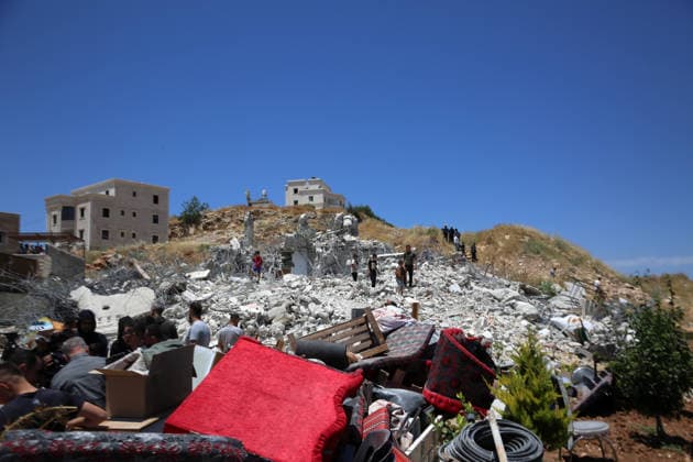 (260608) -- HEBRON, June 8, 2026 -- Palestinians inspect the rubble after Israeli excavators demolished a Palestinian home and a carpentry workshop in the Khirbet Qalqas area, south of Hebron, in the West Bank, on June 8, 2026. (Photo by Xinhua) MIDEAST-HEBRON-DEMOLITION MamounxWazwaz 