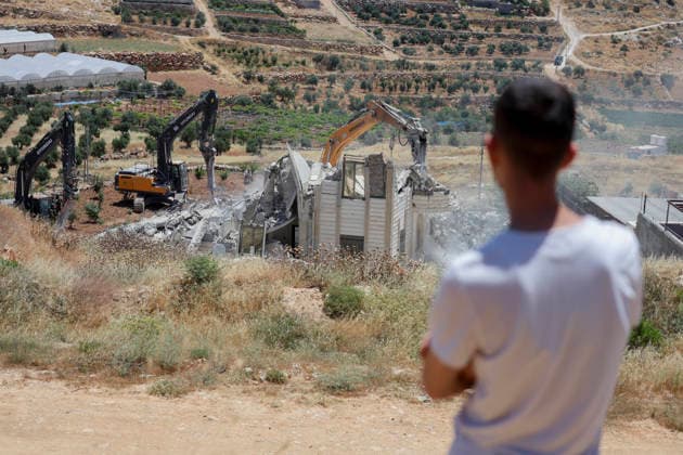 Israeli Residential Building Demolishment West Bank A man looks on as Israeli army heavy machinery demolishes a residential building in the village of Khirbet Qalqas, south of Hebron, in the occupied West Bank, on June 8, 2026. The Israeli army demolished the six-apartment building, which housed 16 people, citing a lack of building permits in Area C. Hebron West Bank Palestinian Territories Copyright: xMosabxShawerx