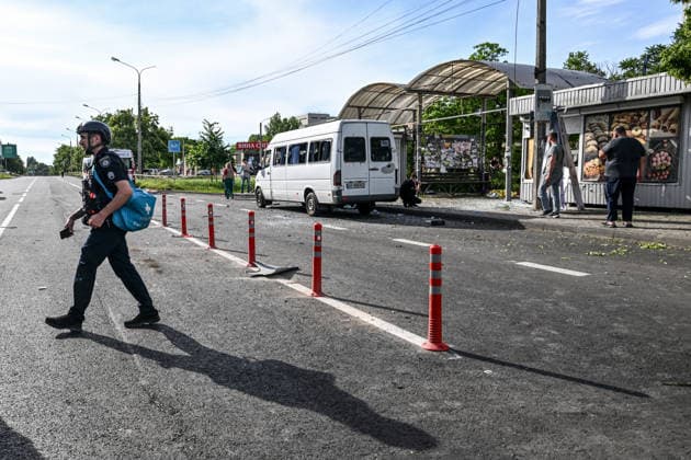 A police officer carrying a medical bag walks past a shared taxi damaged by the blast wave near a public transport stop destroyed in a Russian drone attack in Zaporizhzhia, Ukraine, on June 8, 2026. Russian occupation forces carried out a drone attack on the civilian infrastructure of the southeastern city. The drone hit a residential area, with the explosion occurring near a public transport stop. The blast wave and debris significantly damaged nearby apartment blocks, destroyed and damaged shopping stalls and cars. The impact claimed the lives of two women who were in the zone of the strike. Twenty-four people were injured, including five children and two teenagers. (Photo by Dmytro Smolienko Ukrinform) Deadly Russian drone attack on resi  Copyright: xDmytroxSmolienkox