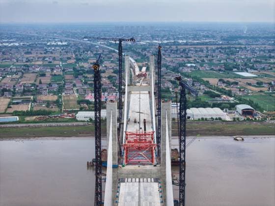 (260609) -- NANTONG, June 9, 2026 -- A drone photo taken on June 9, 2026 shows a view of the Chongqi Highway-Railway Bridge over the Yangtze River between east China s Shanghai and Jiangsu. A key project of the Shanghai-Chongqing-Chengdu high-speed railway, the Chongqi Highway-Railway Bridge was successfully closed here on Tuesday. It has a total length of 4.09 kilometers and a main span of 400 meters. Once opened to traffic, the bridge will reduce the travel time between Shanghai and Qidong of Jiangsu from two and a half hours to less than half an hour. ) CHINA-SHANGHAI-JIANGSU-CHONGQI HIGHWAY-RAILWAY BRIDGE OVER YANGTZE RIVER (CN) JixChunpeng 