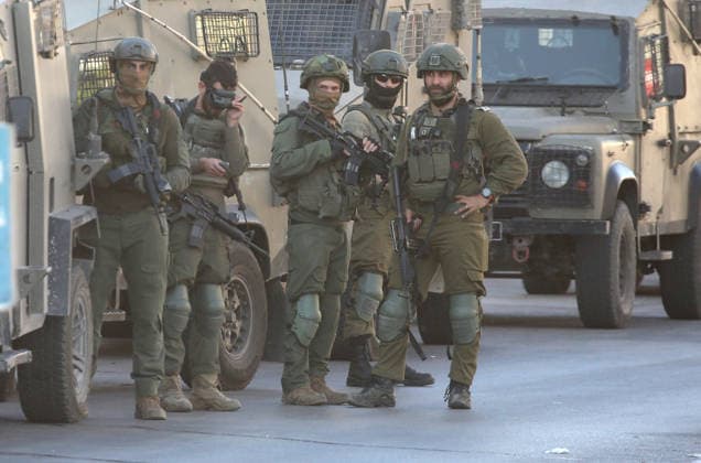 Palestinian - Israeli conflict in Nablus, Palestine - 09 Jun 2026 Israeli soldiers guard military vehicles as they raid homes during a military operation in the Askar refugee camp. Israeli forces raided and searched Palestinian homes as part of a large-scale search and arrest operation that included the Ras al-Ain area, the Old City, and the Askar refugee camp. Palestinians reported that five Palestinians were arrested during the operation. Nablus Palestine Copyright: xNasserxishatyehx xSOPAxImagesx Nishtayeh2226