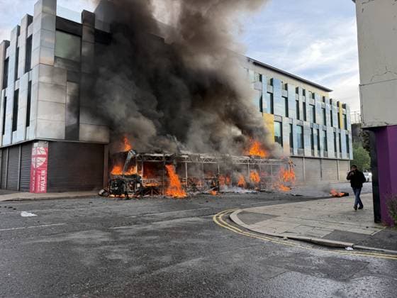 Disorder continues in Belfast after knife attack leaves man seriously injured BELFAST, NORTHERN IRELAND - JUNE 09: Flames and thick black smoke rise from a burning bus during unrest on Sandy Row in Belfast, Northern Ireland, on June 9, 2026. Demonstrations followed a knife attack that left a man seriously injured. Disorder continued in Belfast on Wednesday following a knife attack that left a man seriously injured, with police deploying additional officers as unrest spread across several parts of Northern Ireland s capital. Authorities said a 30-year-old man has been charged with attempted murder in connection with Monday night s attack. He also faces charges of possessing a bladed article in a public place and making threats to kill. Fires  Copyright: x2026xAnadoluxStringerx