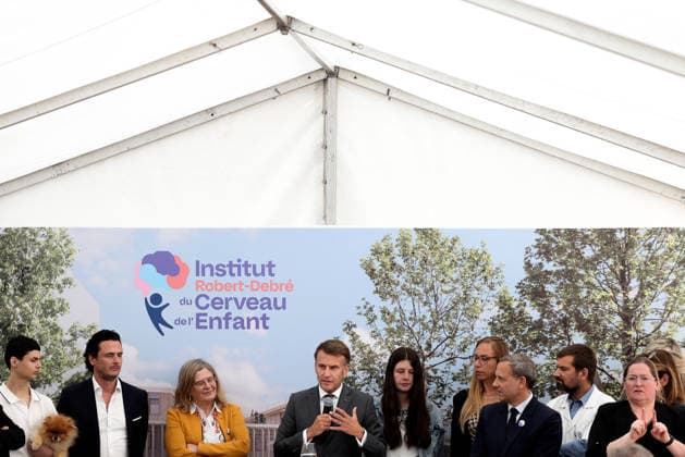 Emmanuel Macron and Brigitte Macron Visit the Robert-Debre Hospital - Paris French President Emmanuel Macron delivers a speech next to Adrien Taquet, Chairman of the Supervisory Board of the Robert-Debre Institute for the Child s Brain and Professor Ghislaine Dehaene during the foundation stone laying ceremony for the Child Brain Institute (ICE - Institut Robert-Debre du Cerveau de l’Enfant) at the Robert-Debre Hospital in Paris, on June 10, 2026. Photo by Stephane Lemouton Pool ABACAPRESS.COM Paris France  Copyright: xLemoutonxStephane Pool ABACAx