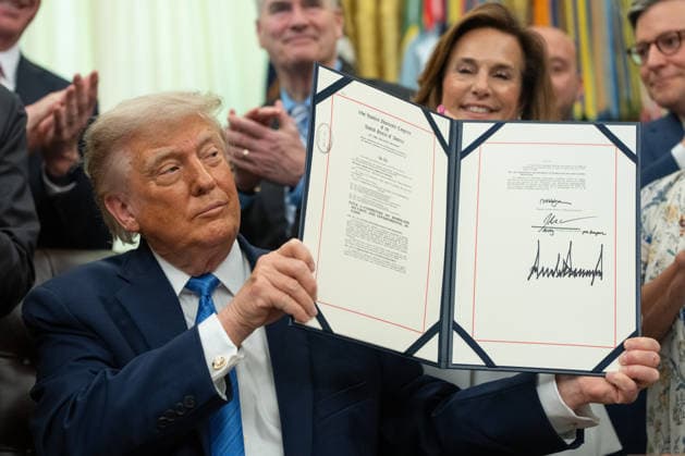 US President Donald Trump displays the signed Secure America Act in the Oval Office of the White House in Washington, DC, US, on Wednesday, June 10, 2026. President Donald Trump prevailed after dissident Republican lawmakers abandoned an effort to leverage a $70 billion spending package to prevent him from reviving a payout fund for political allies who say they were unfairly targeted by the Biden administration.  WAX20260610210 AaronxSchwartz
