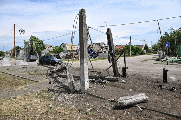 RECORD DATE NOT STATED Russians Hit Zaporizhzhia With KAB Bombs - Ukraine Cars pass power transmission line poles destroyed in a Russian strike with guided aerial bombs in the settlement of Balabyne, Zaporizhzhia region, Ukraine, on June 7, 2026. Russian forces attacked the settlement with guided aerial bombs (KABs), which struck near a public transport stop. Three people were killed and at least five others were injured in the attack. Private homes were also damaged Photo by Dmytro Smolienko Ukrinform ABACAPRESS.COM Zaporizhzhia region Ukraine  Copyright: xSmoliyenkoxDmytro Ukrinform ABACAx