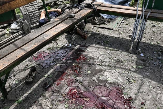 RECORD DATE NOT STATED Russians Hit Zaporizhzhia With KAB Bombs - Ukraine CAUTION, SENSITIVE CONTENT. Bloodstains are seen next to the body of a man killed in a Russian strike with guided aerial bombs at a public transport stop in the settlement of Balabyne, Zaporizhzhia region, Ukraine, on June 7, 2026. Russian forces attacked the settlement with guided aerial bombs (KABs), which struck near the public transport stop. Three people were killed and at least five others were injured in the attack. Private homes were also damaged Photo by Dmytro Smolienko Ukrinform ABACAPRESS.COM Zaporizhzhia region Ukraine  Copyright: xSmoliyenkoxDmytro Ukrinform ABACAx