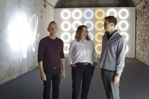 11.06.2026 Unna, NRW, Das Zentrum für Internationale Lichtkunst Unna feiert 25jähriges Jubiläum. Mit der Ausstellung Light Dialogues präseniert das Zentrum eine Kooperation mit dem Schauwerk Sindelfingen. Dabei handelt es sich um eine private Stiftung aus Baden-Würtemberg die eine große Sammlung von Lichtkunstwerken besitzt. Die Ausstellung in Unna zeigt 19 Arbeiten von 11 Lichtkünstlern. Dauer 13. Juni 2026 bis 10. Januar 2027. Das Lichtzenzrum befindet sich in den Katakomben der ehemaligen Lindenbrauerei und bietet ein unnachahmliches Ambiente für die Lichtobjekte. v.li. Direktor John Jaspers, Svenja Frank, Direktorin Schauwerk Sindelfingen und Leonard Lueg vom Lichtkunstzentrum vor Werken von Astrid Klein (li.) und John M. Arm